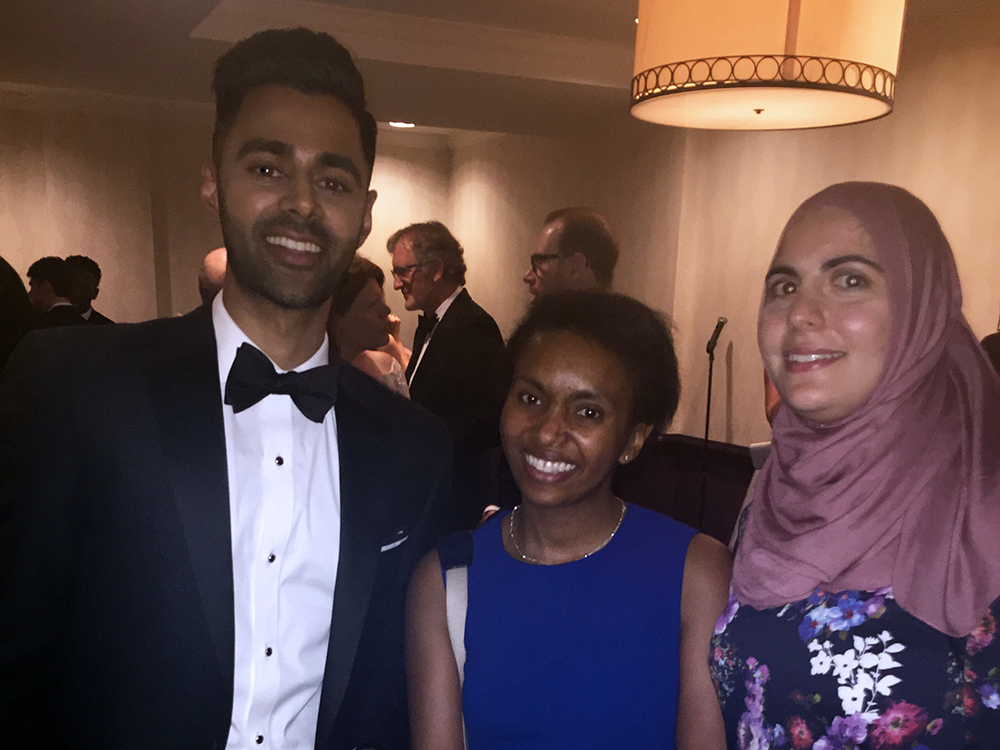 Two students pose for a photo next to Hasan Minhaj at the White House Correspondents Dinner.